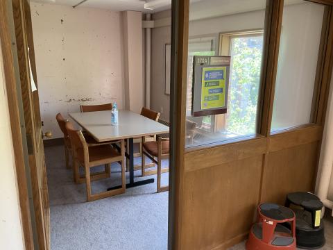 A small, windowed space. Long table in center surrounded by chairs. Whiteboard on right wall. Right wall has a window to the outside; 370A Group Study Room.