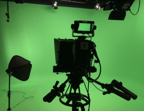 Large media camera and equipment against a green screen